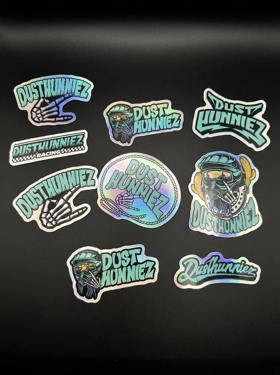 Nine assorted Dusthunniez stickers, mixed holographic and regular finish.